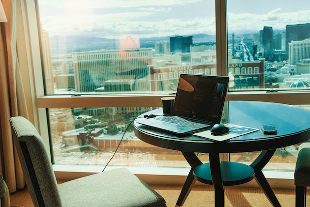 laptop on a table near a window overlooking Las Vegas