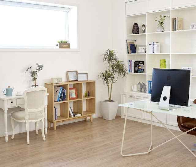 an office with white walls, shelves, and a desk