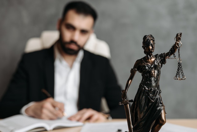 statue of lady justice on a lawyers desk copy