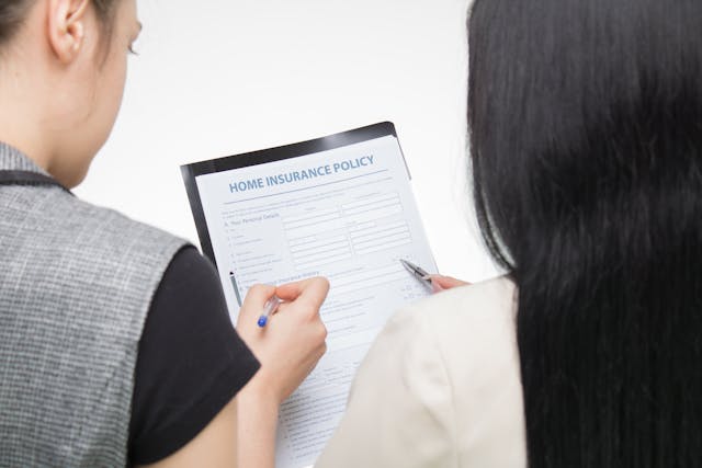 two people looking at a home insurance document