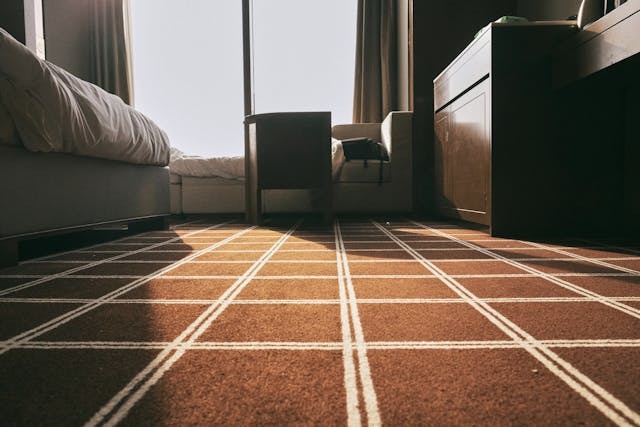 A Bedroom With Brown Carpet Floor