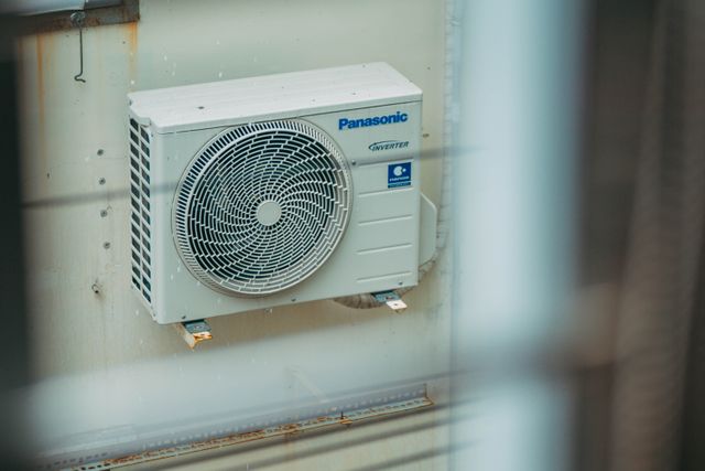air conditioner unit mounted outdoors on a building wall